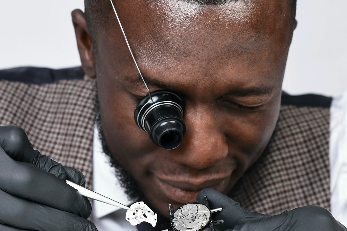 A dealer closely inspecting a watch